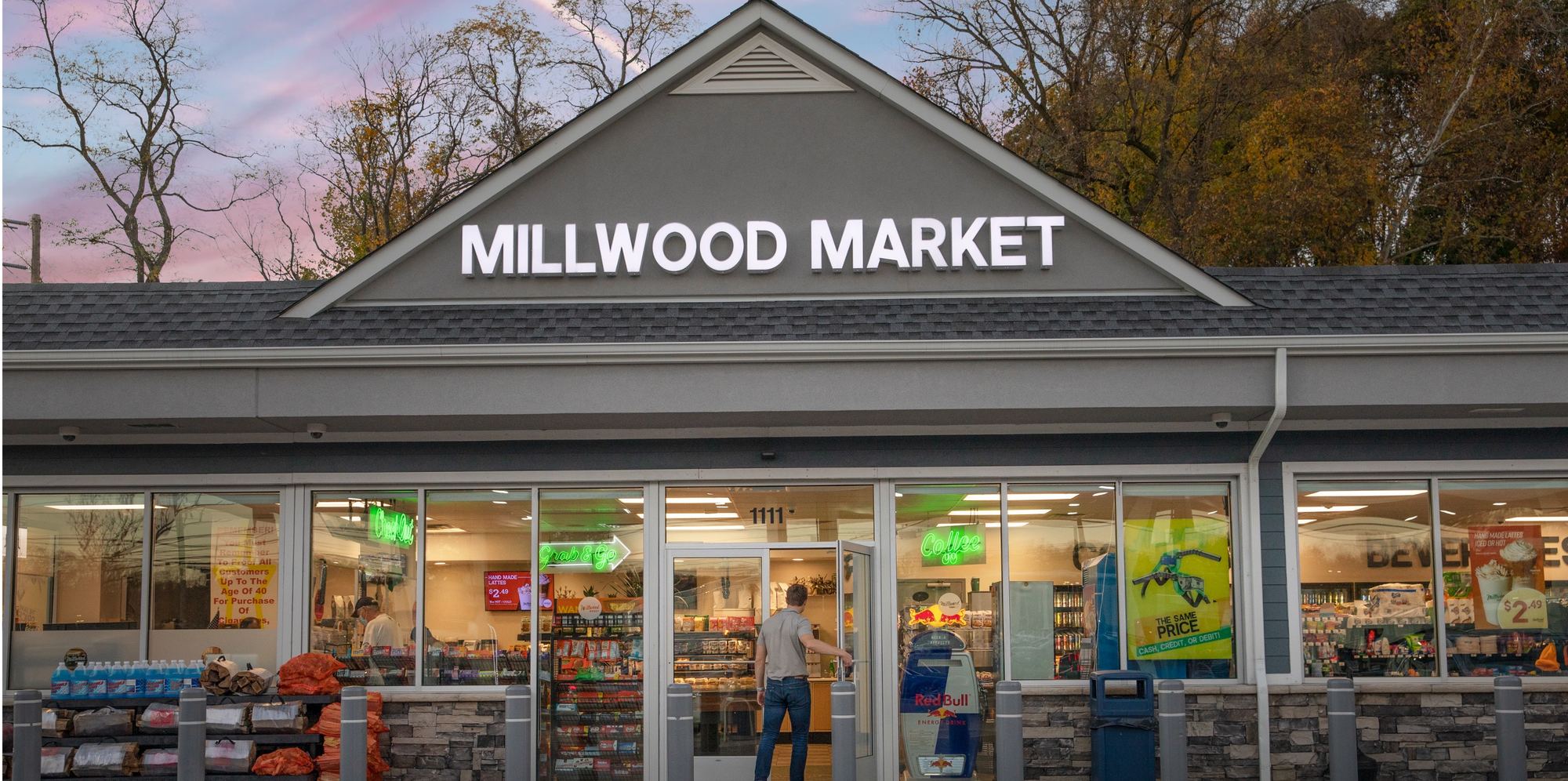 Millwood Market Manhasset storefront at dusk